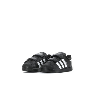 Toddlers' black adidas sneakers with three white stripes and dual hook-and-loop straps