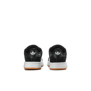 Kids black sneakers with white accents at heel and gum sole