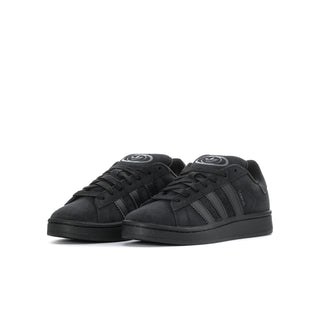 Youth black suede sneakers, side-by-side angled view, lace-up with three stripes