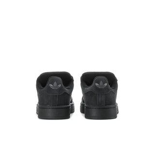 Youth black suede sneakers, rear view with heel tabs and cushioning