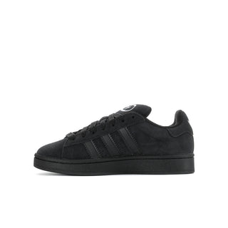Youth black suede sneakers, opposite side view, lace-up with three stripes