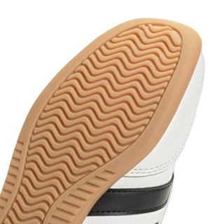 Youth sneaker outsole close-up with wavy tread and gum edge