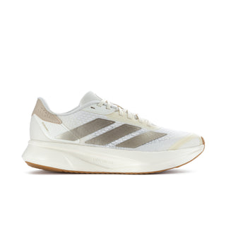 Women's white running shoes with metallic gray stripes and tan rubber sole