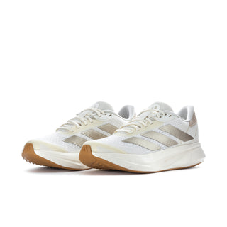 Women's white running shoes with metallic gray overlays and tan outsole