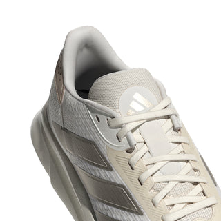 Women's shoe upper close-up with white laces, gray stripes, and cushioned tongue