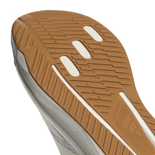Women's outsole close-up with tan tread pods and white rim sole