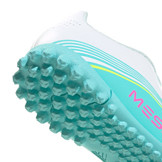 Youth soccer cleat toe close-up showing aqua textured studs on the turf outsole