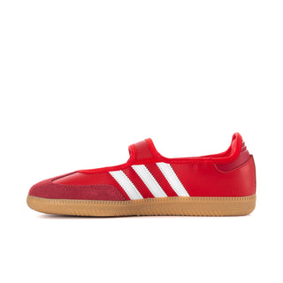 Red adidas low-top sneakers with white side stripes and gum sole.