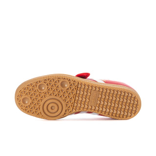Gum rubber outsole for red adidas sneakers with textured traction pattern.