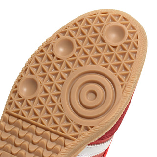 Close-up of gum rubber outsole tread for adidas red sneakers.