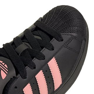 Kids adidas Superstar II toe and lace panel close-up, black with pink 3-stripe overlays