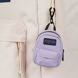 Lilac mini backpack close-up with Jansport logo, front zip pocket, black zipper pulls
