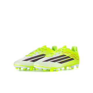 Youth soccer cleats in neon yellow with black and red stripes, FG studs