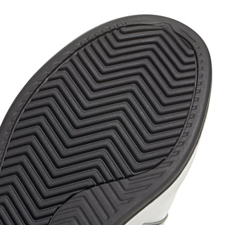 Men's adidas outsole close-up with deep chevron tread for traction.