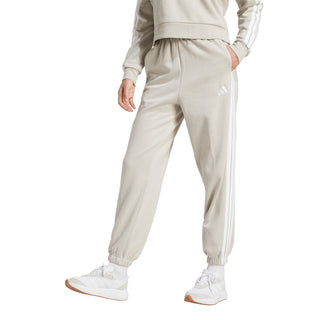 Womens light beige loose track pants, side view, white 3-Stripes and cuffed hem