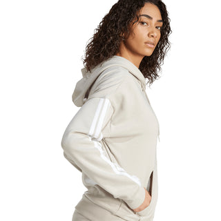 Women's light gray zip hoodie, side view, hooded with three-stripe sleeve detail