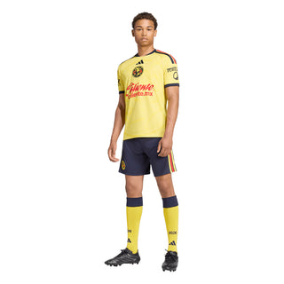 Yellow mens soccer home jersey with navy collar and matching navy shorts with red stripe