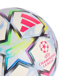 UEFA Champions League soccer ball close-up, star patch with UEFA logo and bright pink text