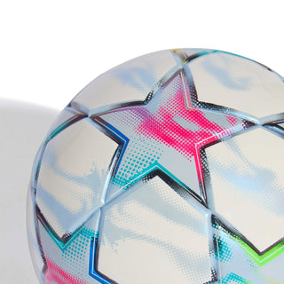 Close-up of white mini soccer ball with blue and pink star-shaped patterns