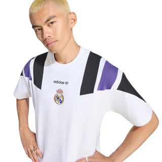 Close-up of men’s white Real Madrid tee with adidas logo and black/purple stripe panels