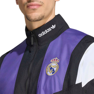 Close-up of men's Real Madrid EQT track jacket: adidas logo, hood, zip, club crest