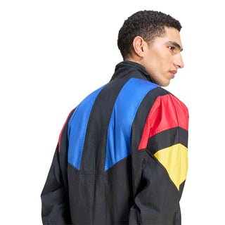 Mens black track jacket side view with blue shoulder panel, red sleeve panel, yellow accent