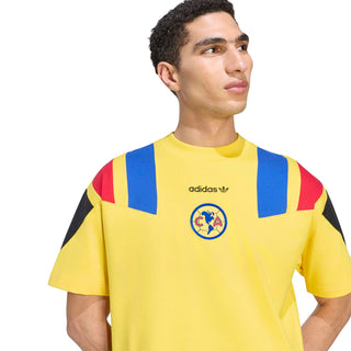 Men's yellow soccer T-shirt close-up: blue/red shoulder stripes and crest