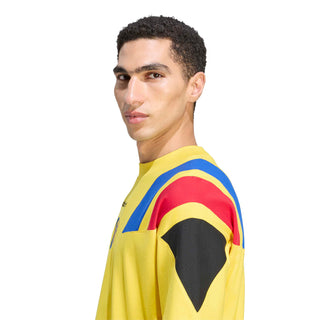 Men's yellow soccer T-shirt side view with blue/red stripe sleeve and crest