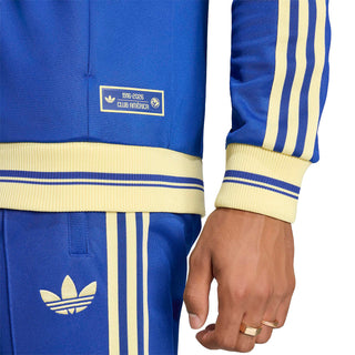 Mens blue track jacket hem and sleeve cuff with gold stripe trim and small patch