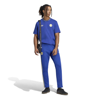 Men's blue track pants with vertical side stripes and logo accents