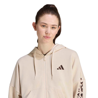 Women’s beige zip-up hoodie with drawstring hood and adidas logo near shoulder