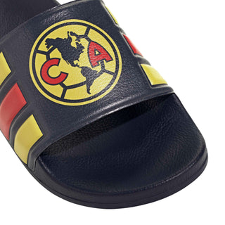 Men's slide sandal strap close-up with circular club crest and yellow-red stripes