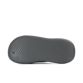 Grey slide sandal outsole with circular traction pattern