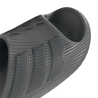 Grey slide sandal side view with textured straps and cushioned footbed