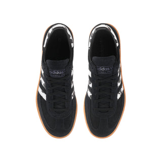Youth black sneakers with white serrated stripes, lace-up front, gum sole
