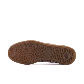 Gum-colored outsole of women's low-top sneaker with embossed adidas branding and traction tread.