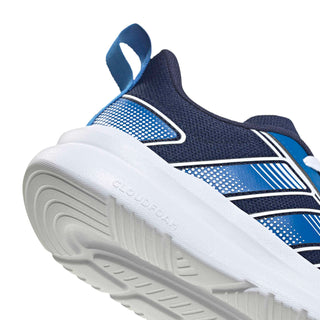 Youth sneaker side close-up, navy upper with blue accents on white cushioned sole