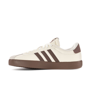 Women’s off-white low-top sneakers with three brown stripes and brown platform sole