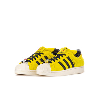 Youth yellow low-top sneakers with black striped sides and Pikachu character details