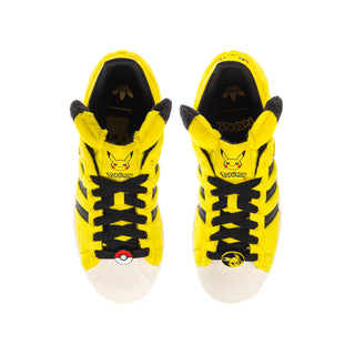 Pair of yellow youth sneakers with black laces, Pikachu face print, and plush ear trim