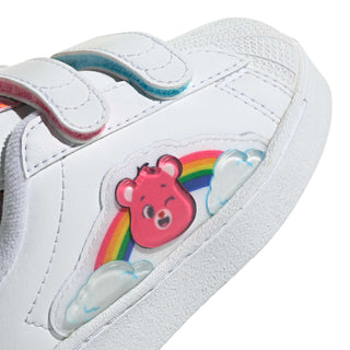 Toddler sneaker close-up: white upper with red Care Bears face and rainbow graphic