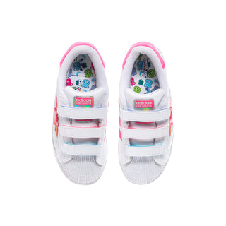 Kids' white sneakers with pink-lined straps and Care Bears patterned inner lining