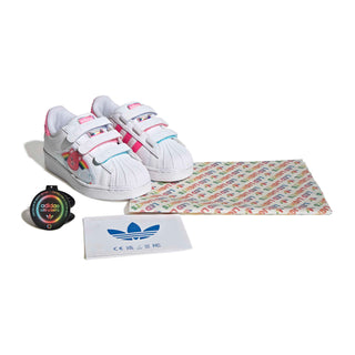 Kids' white Care Bears sneakers with straps, plus shoe care label and box tag
