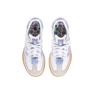 Kids' white low-top sneakers with purple accents and Care Bears graphics on tongue and upper