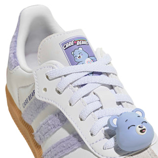 Kids' sneaker upper close-up with Care Bears patch and white laces plus bear charm