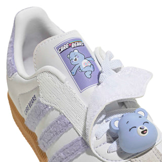 Kids' sneaker upper close-up with Care Bears patch and plush bear charm on laces