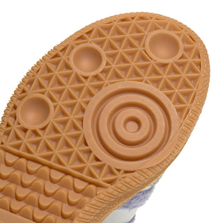 Kids' gum outsole close-up with circular tread and textured grip pattern