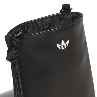 Black flat crossbody bag close-up with Adidas trefoil logo and braided drawstring