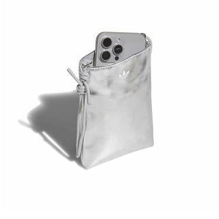 Metallic silver flat crossbody bag with adidas trefoil logo and phone in pocket