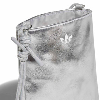 Metallic silver flat crossbody bag close-up with adidas trefoil and drawstring zipper